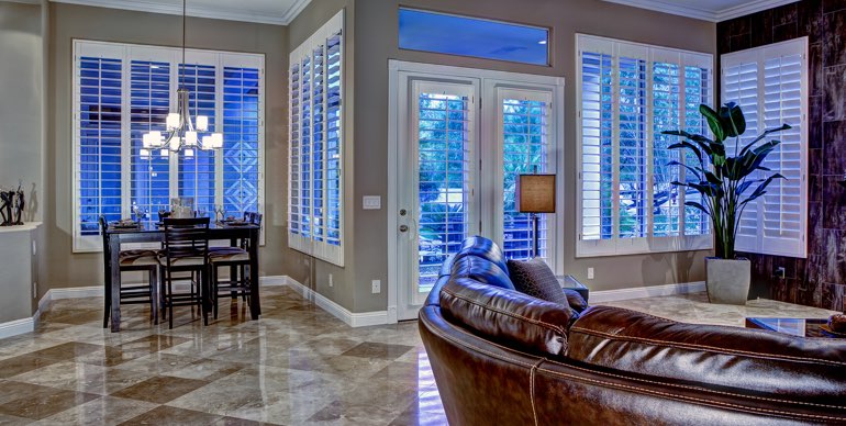 Photo Courtesy of Room Resolutions Phoenix great room with plantation shutters and leather furniture.